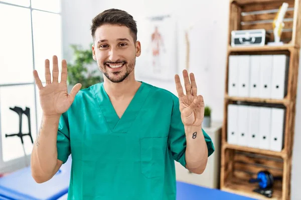 Young Physiotherapist Man Working Pain Recovery Clinic Showing Pointing Fingers — Stok fotoğraf