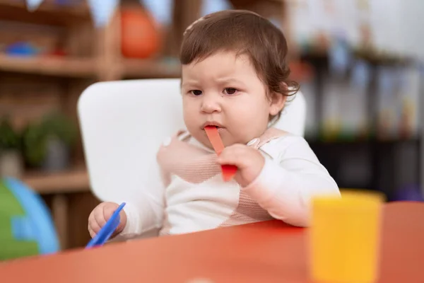 Adorable Toddler Sitting Table Sucking Plastic Spoon Holding Dish Kindergarten — Stock Photo, Image