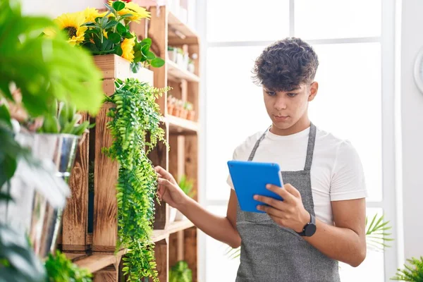 Young Hispanic Teenager Florist Using Touchpad Touching Plant Flower Shop — Stok fotoğraf