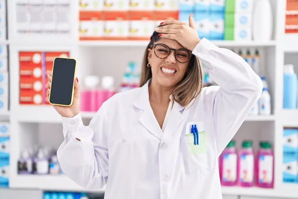 Blonde Woman Working Pharmacy Drugstore Showing Smartphone Screen Stressed Frustrated — ストック写真