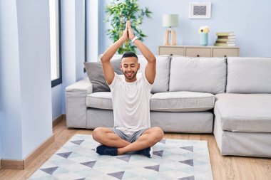 African american man smiling confident training yoga at home