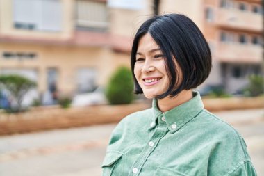 Young chinese woman smiling confident standing at street