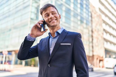 Young man business worker smiling confident talking on smartphone at street