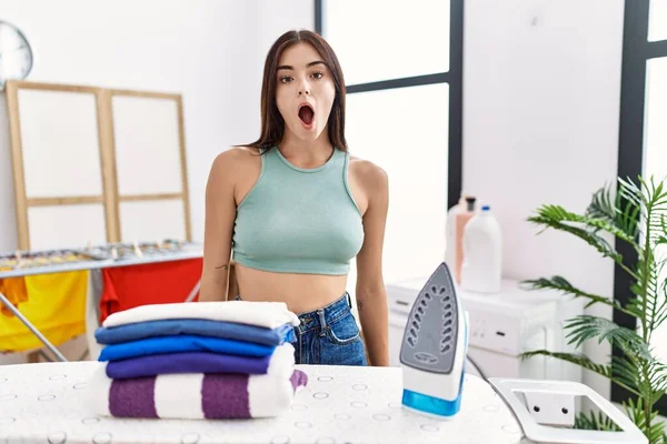 Young Hispanic Woman Ironing Clothes Laundry Room Afraid Shocked Surprise — Fotografia de Stock
