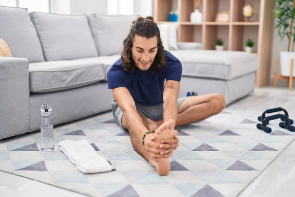Young Hispanic Man Stretching Leg Sitting Floor Home — Stock Photo, Image