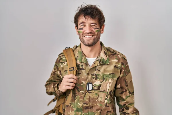 Hispanic Young Man Wearing Camouflage Army Uniform Winking Looking Camera — Stock Photo, Image