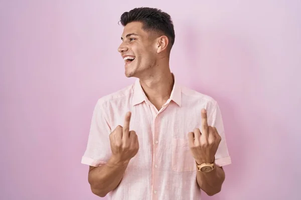 Young Hispanic Man Standing Pink Background Showing Middle Finger Doing — Stok fotoğraf