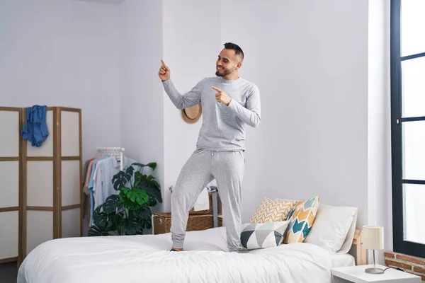 Young Hispanic Man Standing Bed Dancing Bedroom — Fotografia de Stock
