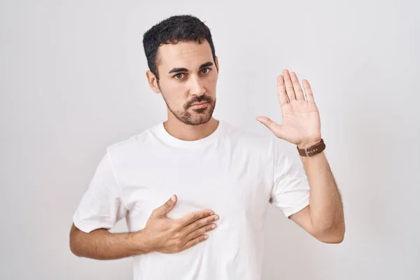 Handsome Hispanic Man Standing White Background Swearing Hand Chest Open — 图库照片
