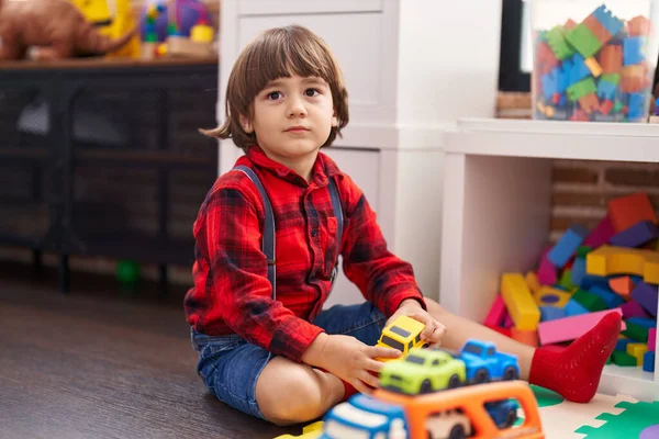 stock image Adorable toddler playing with car toy sitting on floor at home