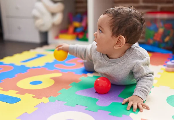 Bedårande Hispanic Baby Leka Med Bollar Liggande Golvet Dagis — Stockfoto