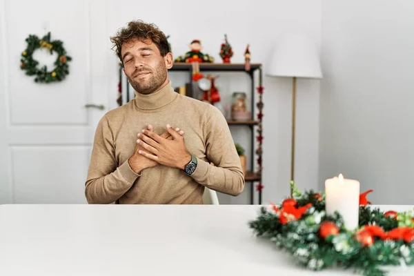 Young Handsome Man Beard Sitting Table Christmas Decoration Smiling Hands — 图库照片