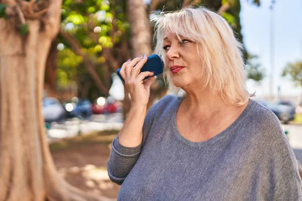 Middle Age Blonde Woman Listening Audio Message Smartphone Park — Fotografia de Stock