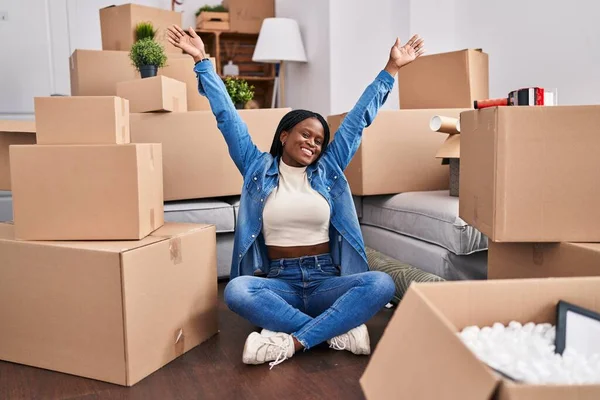 African American Woman Stretching Arms Sitting Floor New Home — Foto Stock