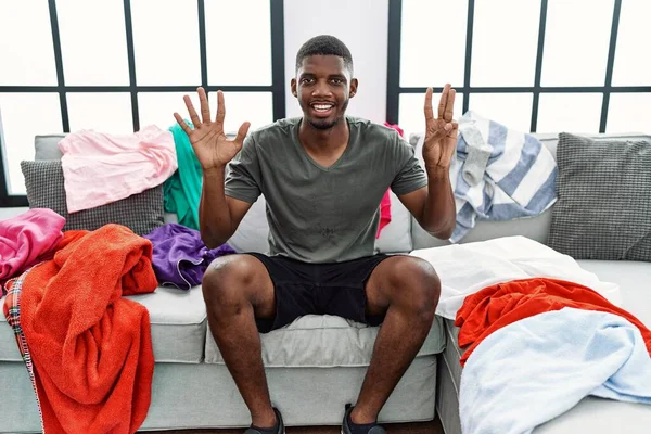 Young African American Man Sitting Sofa Dirty Laundry Clothes Showing — Stock Photo, Image