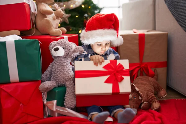 Adorable Toddler Unpacking Christmas Gift Sitting Floor Home — Fotografia de Stock