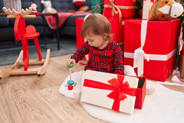 Adorable Hispanic Girl Unpacking Gift Sitting Floor Christmas Tree Home — Stok fotoğraf