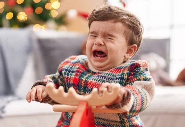 Adorable Hispanic Toddler Crying Playing Reindeer Rocking Christmas Tree Home — Stock Photo, Image