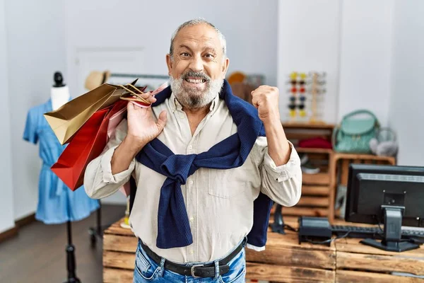 Handsome Senior Man Holding Shopping Bags Boutique Shop Screaming Proud — Stock Photo, Image