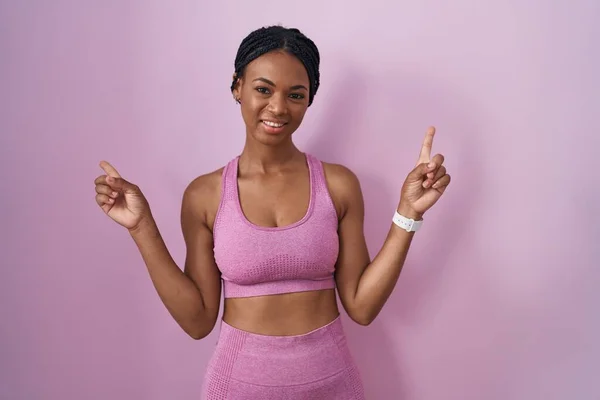 African American Woman Braids Wearing Sportswear Pink Background Smiling Confident — Zdjęcie stockowe