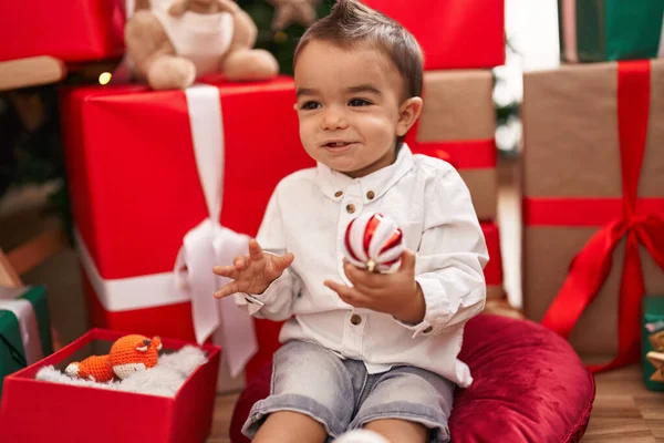Adorable Hispanic Toddler Unpacking Christmas Gift Sitting Floor Home — Stock Photo, Image