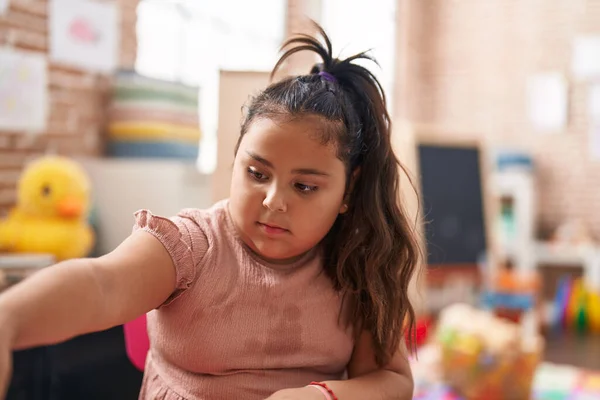 Size Hispanic Girl Sitting Table Relaxed Expression Kindergarten — Stockfoto