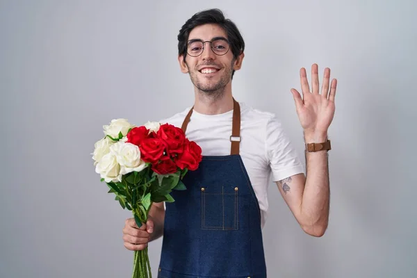 Young Hispanic Man Holding Bouquet White Red Roses Waiving Saying — Stock fotografie