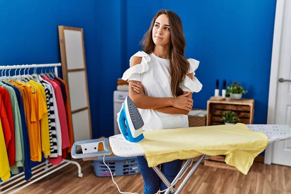Young Hispanic Woman Ironing Clothes Laundry Room Smiling Looking Side — ストック写真