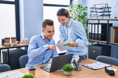 Man and woman business workers using laptop working at office