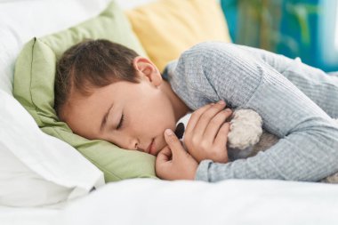 Adorable toddler lying on bed sleeping at bedroom