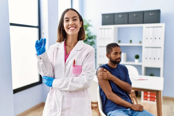 Young Doctor Woman Holding Vaccine Showing Syringe Looking Positive Happy — Stock Photo, Image