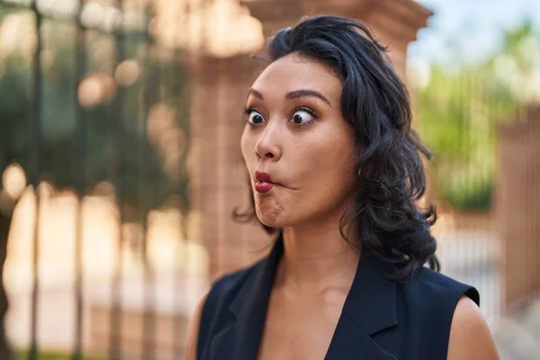 stock image Young beautiful hispanic woman smiling confident doing funny gesture with lips at street