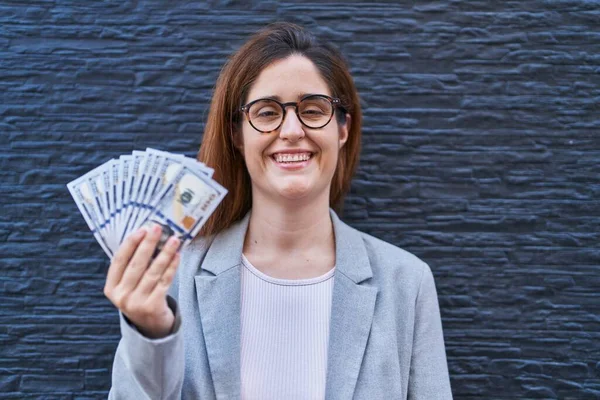 Brunette Woman Holding Dollars Looking Positive Happy Standing Smiling Confident — Stock Photo, Image