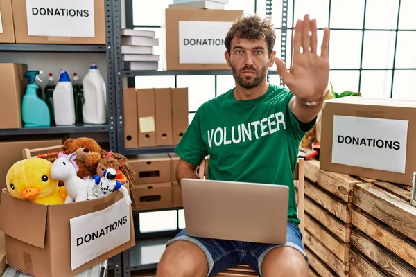 Young Handsome Man Wearing Volunteer Shirt Using Laptop Doing Stop — Stock Photo, Image