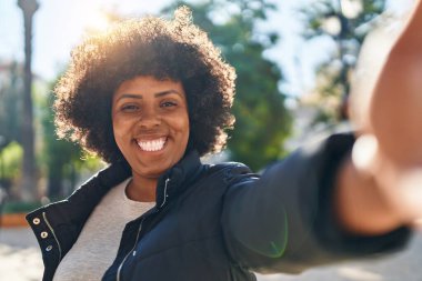 African american woman smiling confident making selfie by camera at park