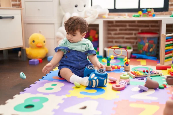 Adorable Hispanic Toddler Sitting Floor Serious Expression Playing Kindergarten — Stock Photo, Image