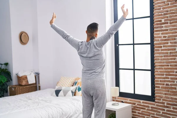Young Hispanic Man Waking Stretching Arms Bedroom — Stock fotografie