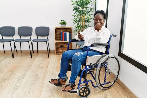 Young Black Woman Sitting Wheelchair Waiting Room Pointing Back Hand — Stockfoto