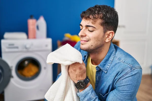 Young Hispanic Man Smelling Towel Standing Laundry Room — Stock Photo, Image