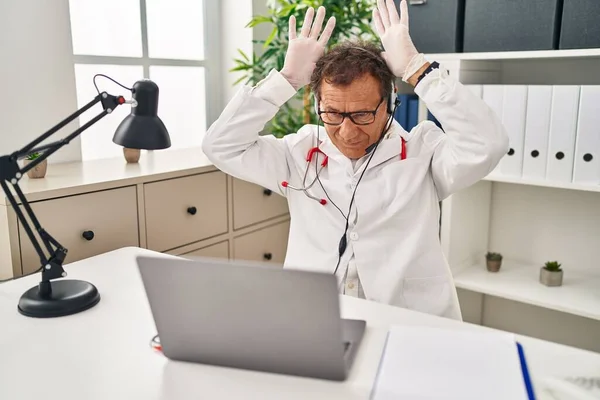 Senior Doctor Man Working Online Appointment Doing Bunny Ears Gesture — Stock Photo, Image