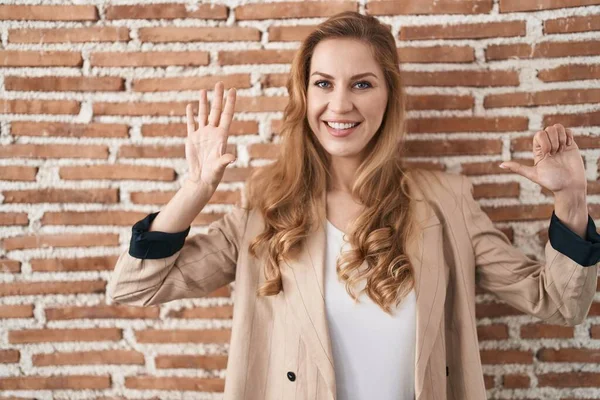 Beautiful Blonde Woman Standing Bricks Wall Showing Pointing Fingers Number — Stock fotografie