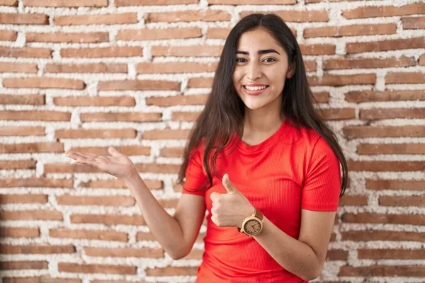 Young Teenager Girl Standing Bricks Wall Showing Palm Hand Doing — Stock fotografie