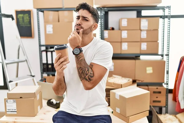 Young Hispanic Man Working Small Business Ecommerce Drinking Coffee Serious — Foto de Stock