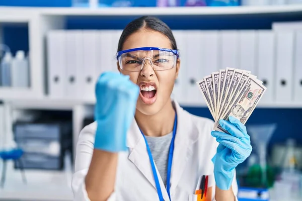 Young Brazilian Woman Working Scientist Laboratory Holding Money Annoyed Frustrated — Stok fotoğraf