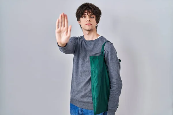 Young Man Wearing Reusable Bag Open Hand Doing Stop Sign — Foto de Stock
