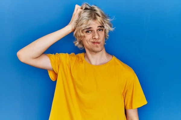 Young Modern Man Standing Blue Background Confuse Wonder Question Uncertain — Stockfoto