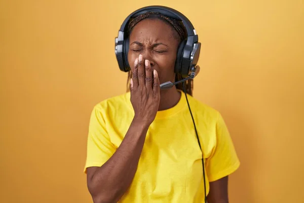 African American Woman Listening Music Using Headphones Bored Yawning Tired — Stock Photo, Image