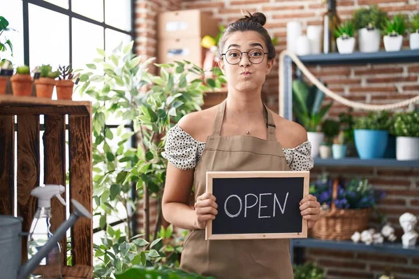 Hispanic Woman Working Florist Holding Open Sign Puffing Cheeks Funny — Stock Photo, Image
