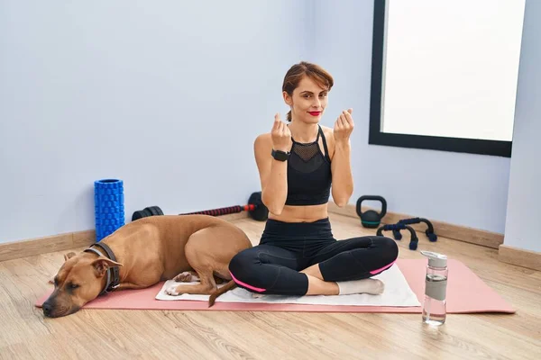Young Beautiful Woman Sitting Yoga Mat Doing Money Gesture Hands — Stock Photo, Image