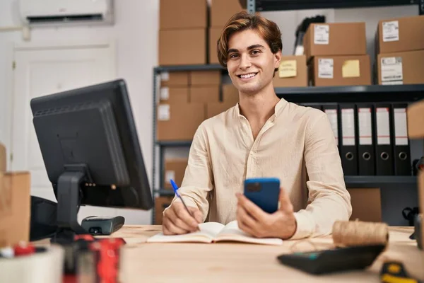 Young Caucasian Man Ecommerce Business Worker Using Smartphone Writing Notebook — Stockfoto
